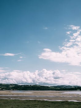Idyllic rural landscape with clouds and open fields in Conwy, Wales.
