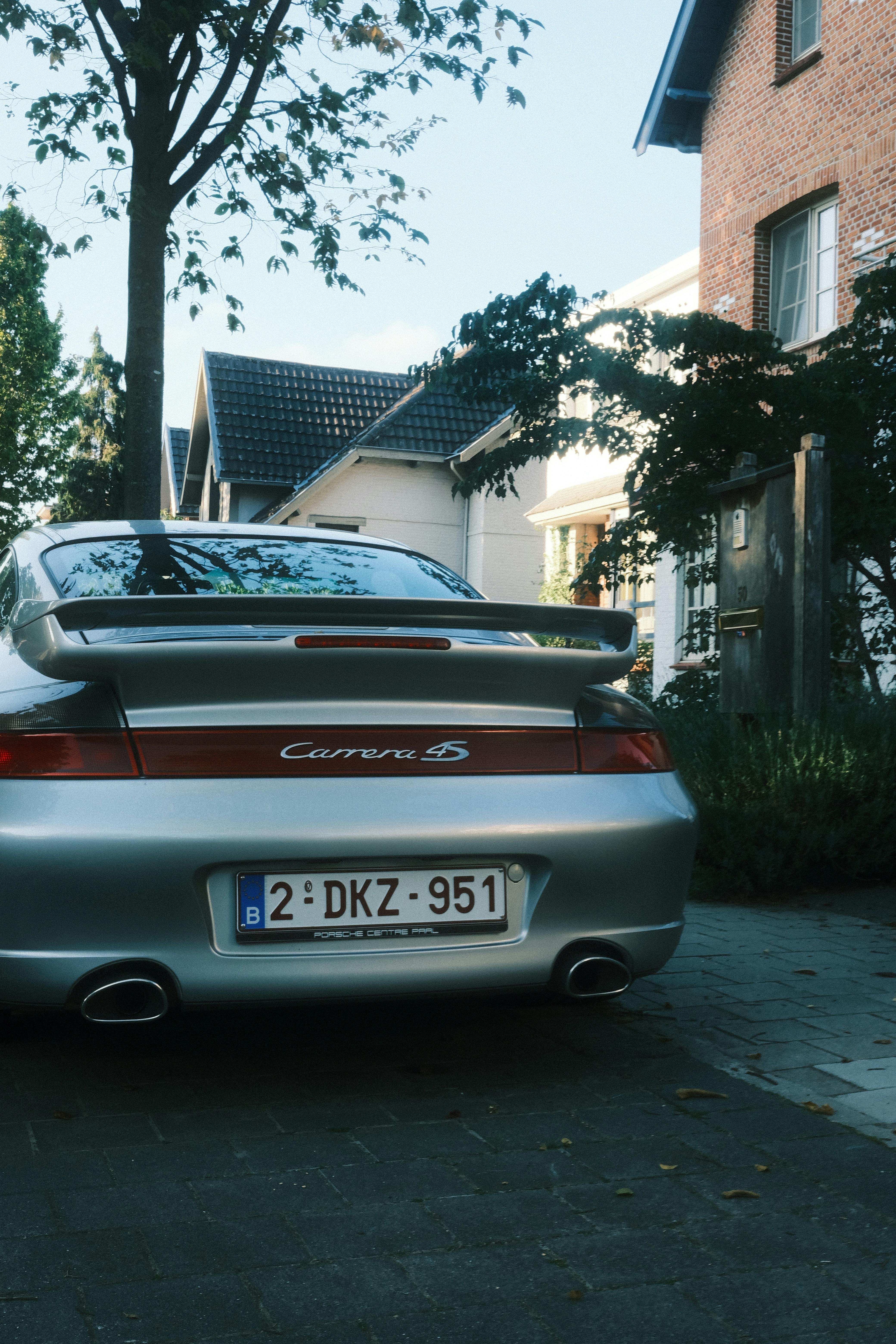 A stylish sports car parked on a quiet residential street in an urban neighborhood.
