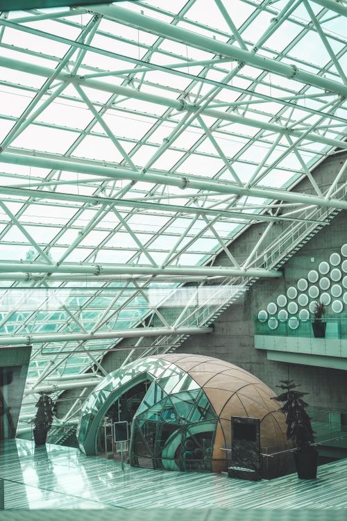 Free A modern architectural interior with a glass roof and geometric design elements. Stock Photo