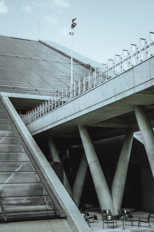 Free A striking view of modern concrete architecture with steel columns and minimal furniture. Stock Photo
