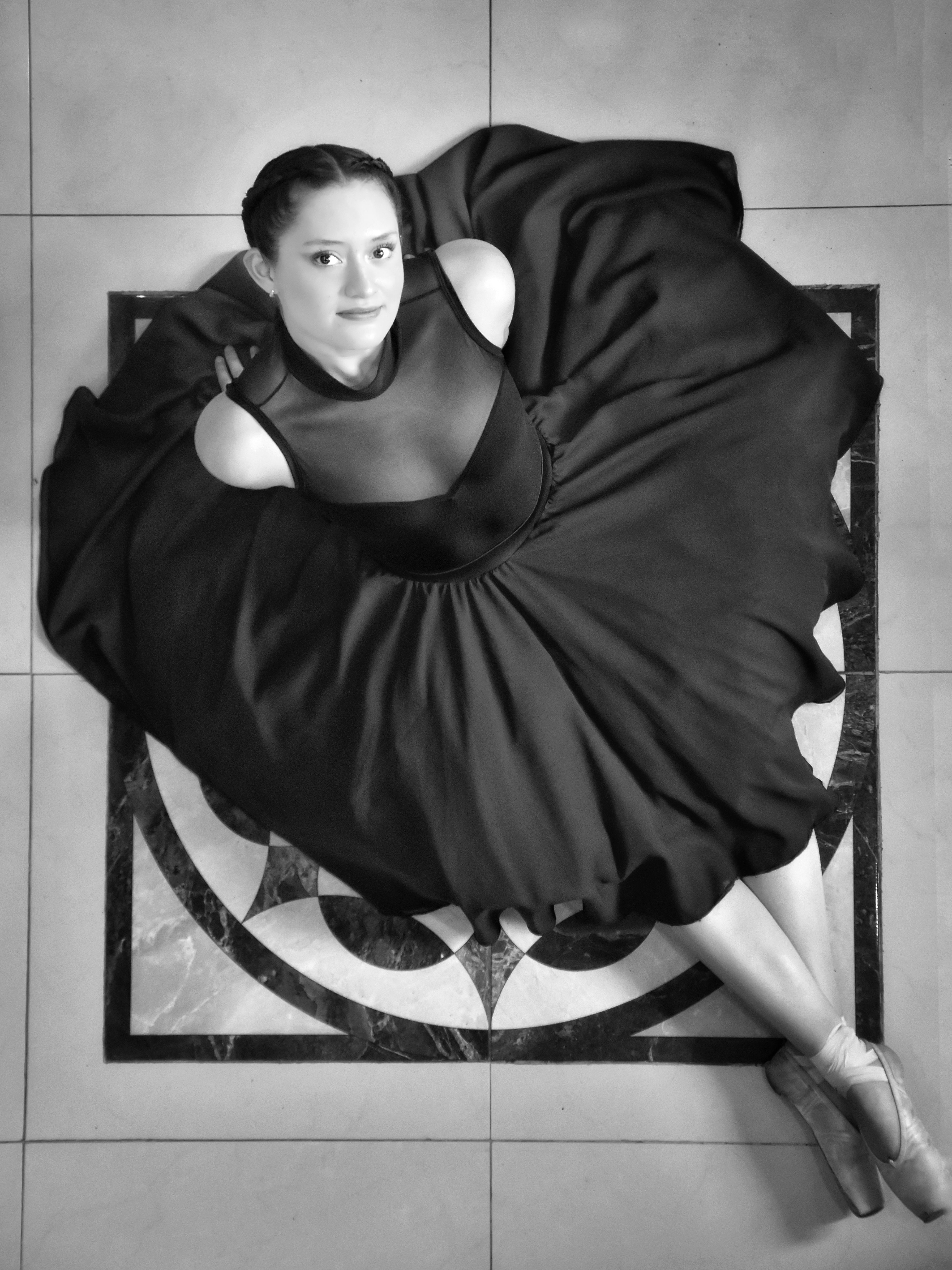 A woman in a black dress sitting on the floor · Free Stock Photo