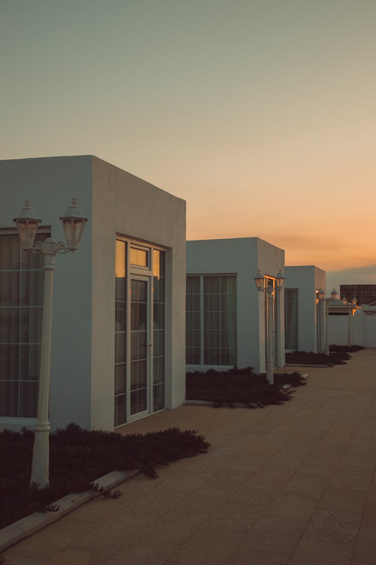 Rows Of Houses By Street At Sunset