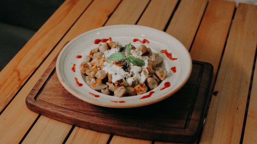 White plate with momo and sauce