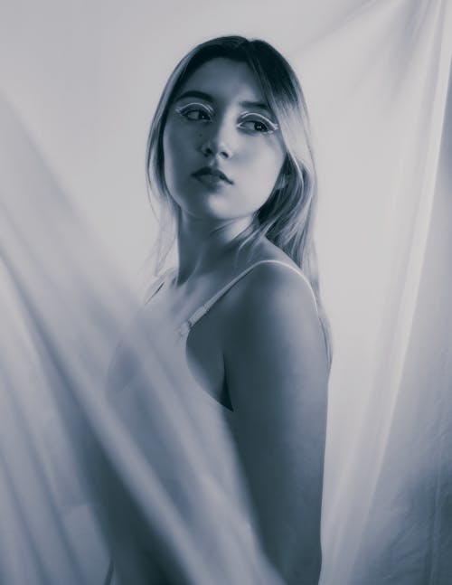 Portrait of Woman behind Curtain in Black and White