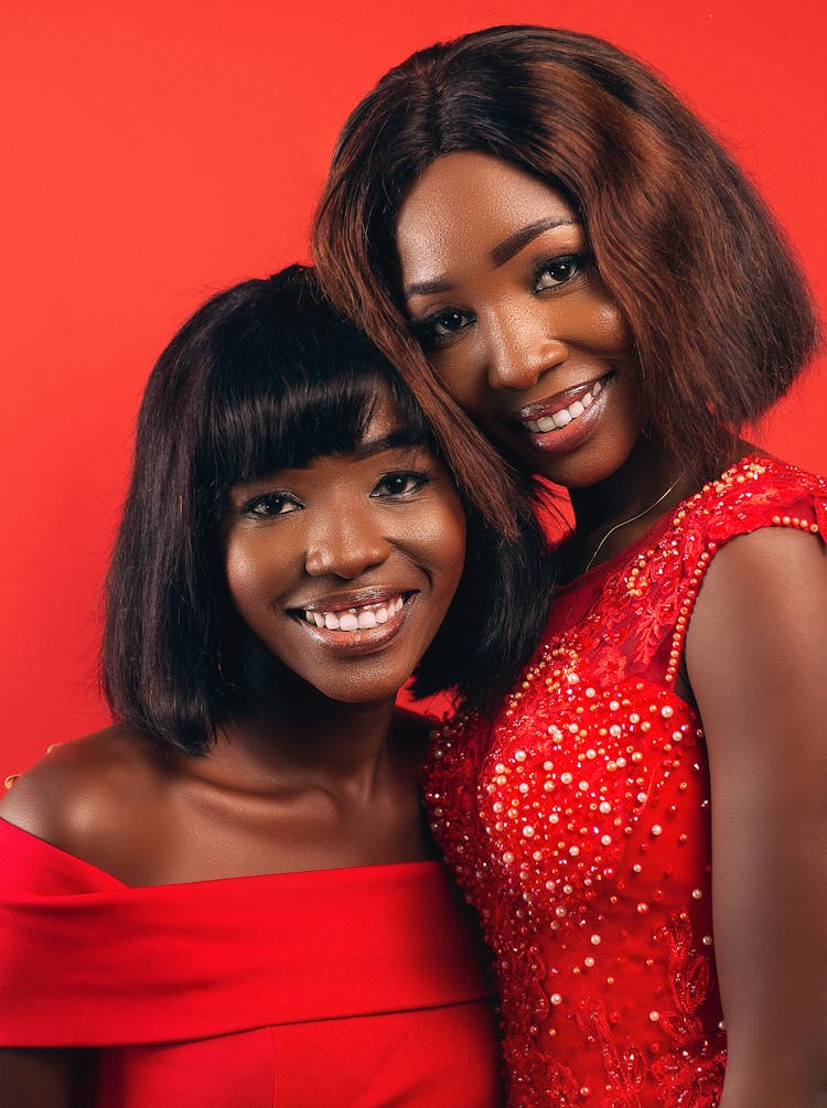 Women Posing In Red Background