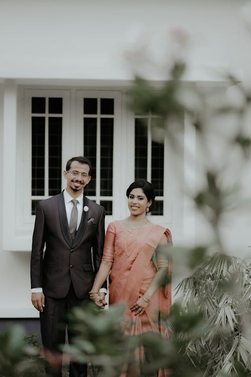 Smiling Newlyweds in Suit and Dress