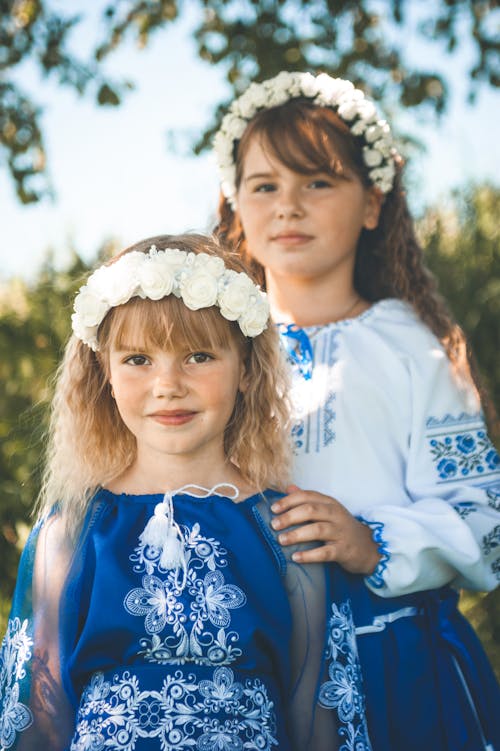 Two Little Girls Wearing Dresses and Flower Crowns 