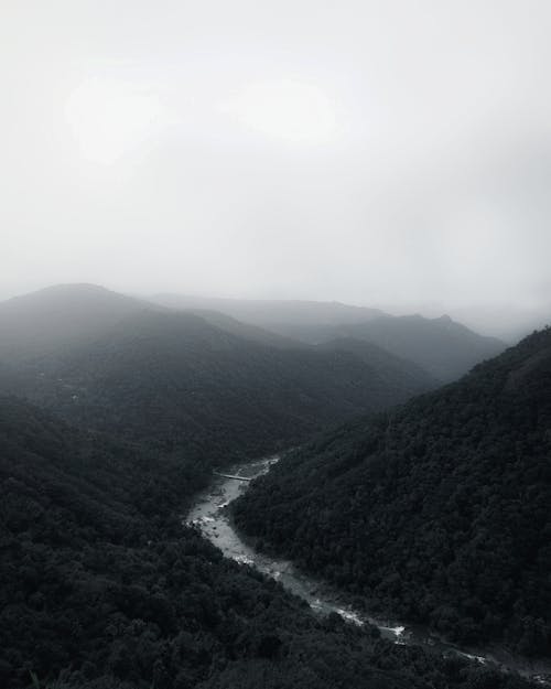 Aerial View of Mountains and River in the Valley 