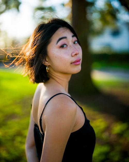 Beautiful Young Woman Standing in Park Half Body Look Backwards