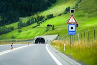 View of a Road in Mountains Leading to a Tunnel