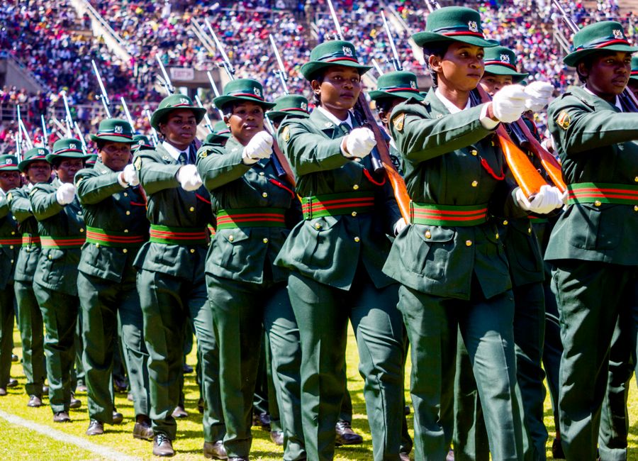 Uniformed women participating in a military parade at a stadium in Harare, Zimbabwe.