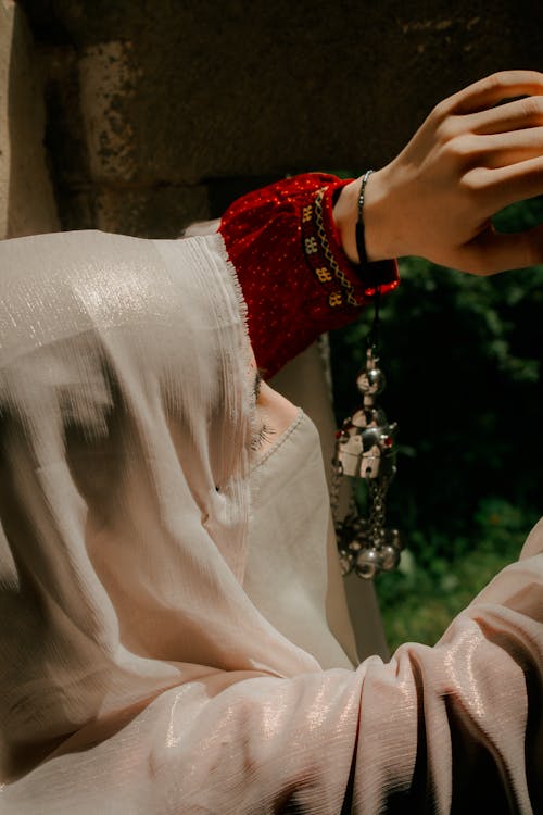 A Woman in a Headscarf Standing Outside 