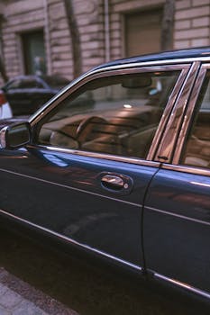 Close-up of a parked vintage car on a city street in Baku, Azerbaijan.