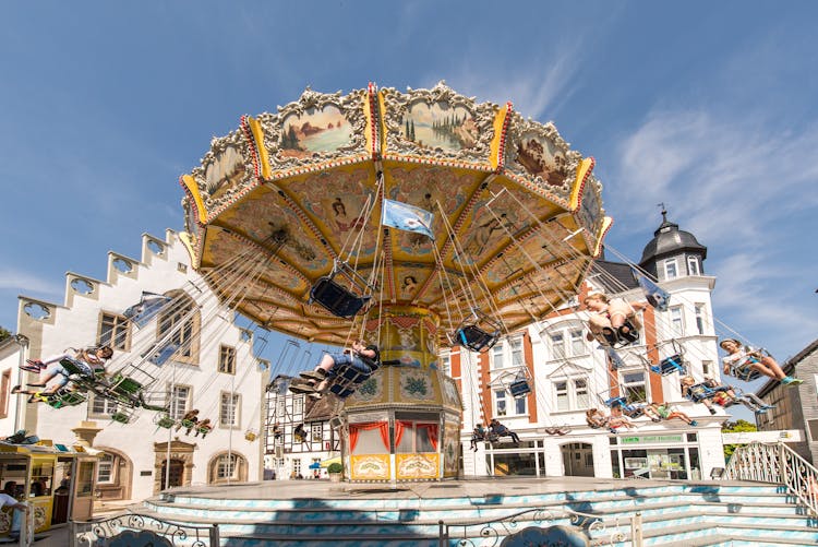 View Of People Riding On A Carousel In Brakel, Germany