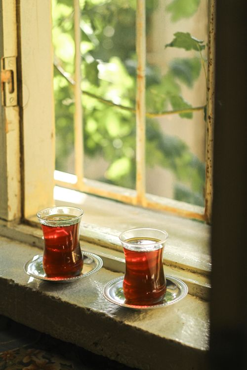 Free Two cups of Turkish tea on a windowsill, bathed in warm sunlight, evoking a cozy ambiance. Stock Photo