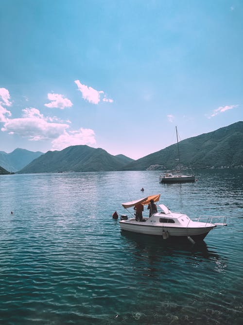 View of Boats on a Lake Surrounded with Mountains 