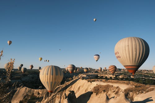 Hot Air Balloons Flying over the Mountains, Cappadocia, Turkey