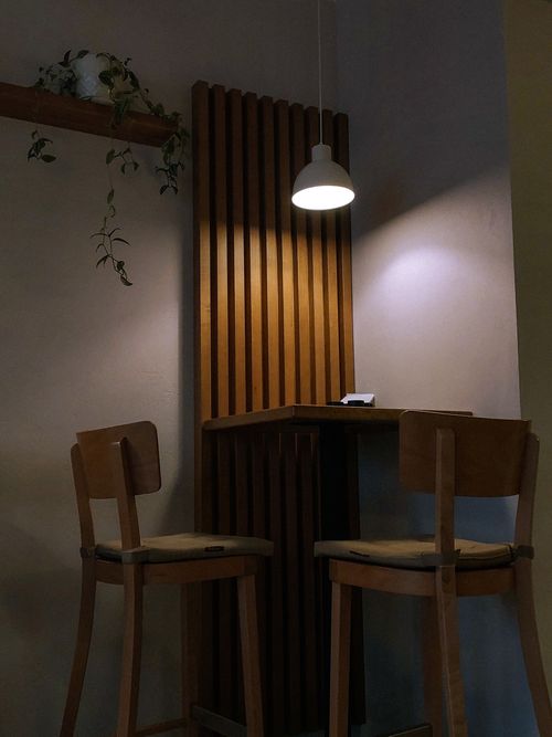 Free Inviting café interior in Kyiv featuring wooden elements and soft lighting, perfect for intimate gatherings. Stock Photo