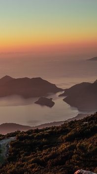 A stunning view of the sunset over Fethiye's coastline, capturing serene waters and lush landscapes.
