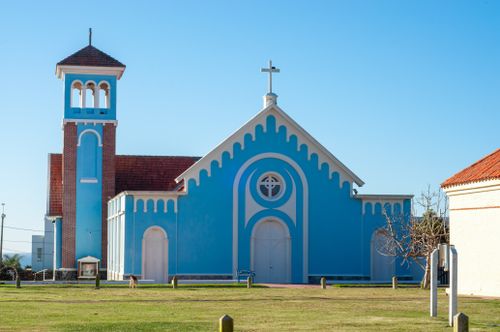 Free This vibrant blue church in Punta del Este showcases classic architecture amidst a clear summer sky. Stock Photo