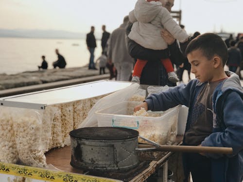 A Boy Making and Selling Popcorn on the Beach 