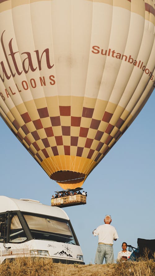 People Looking at a Flying Hot Air Balloon, Cappadocia, Turkey
