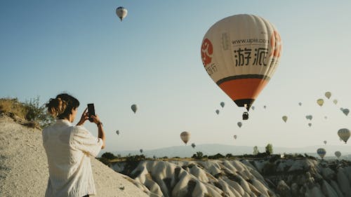 Woman Taking Pictures of Hot Air Balloons in Cappadocia