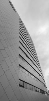 Black and white vertical shot of a modern building facade in Ankara.