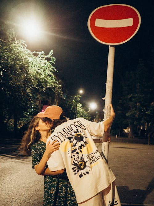 Couple Kissing Under Prohibition Sign