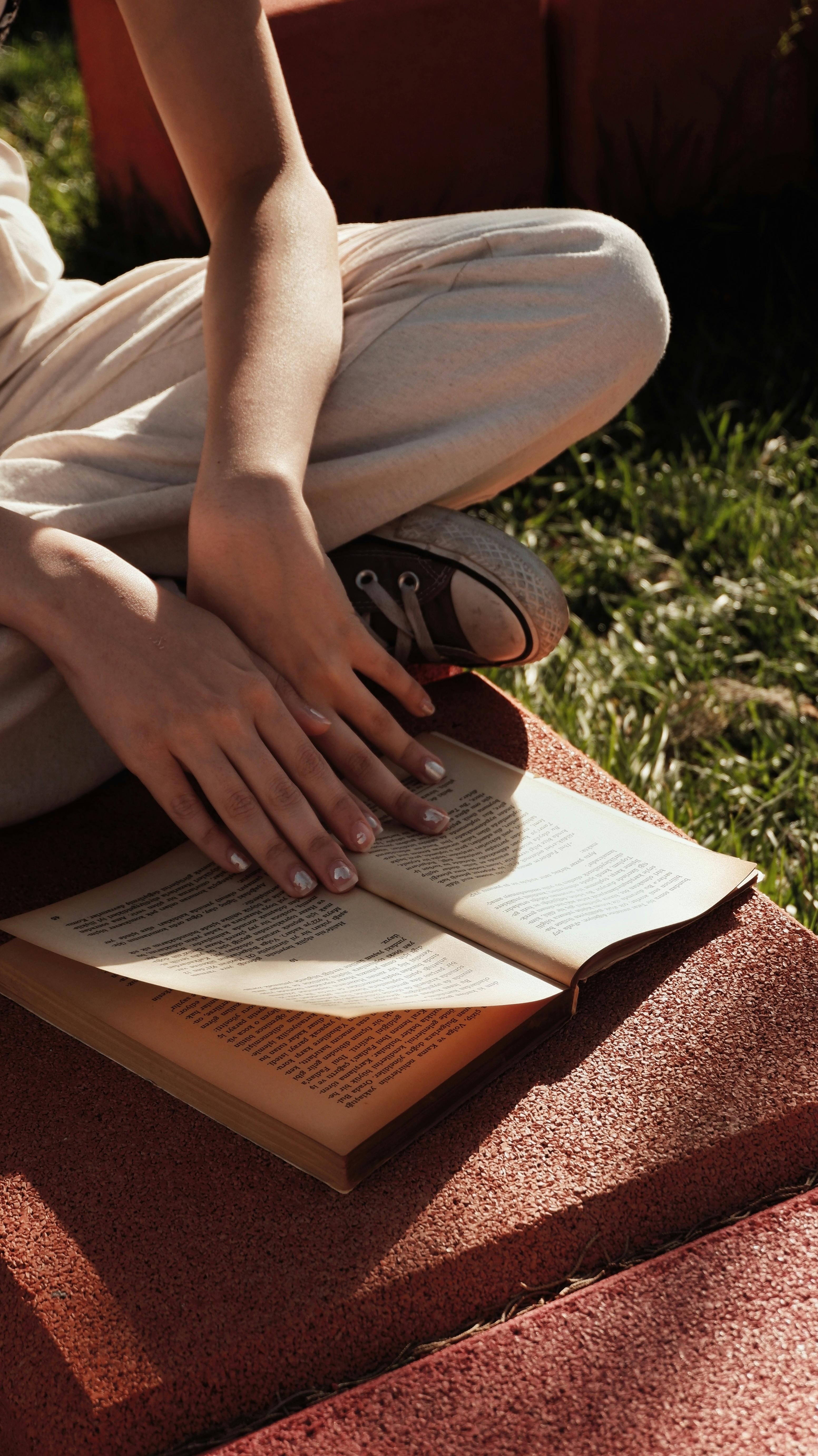 Woman Hands on Open Book · Free Stock Photo