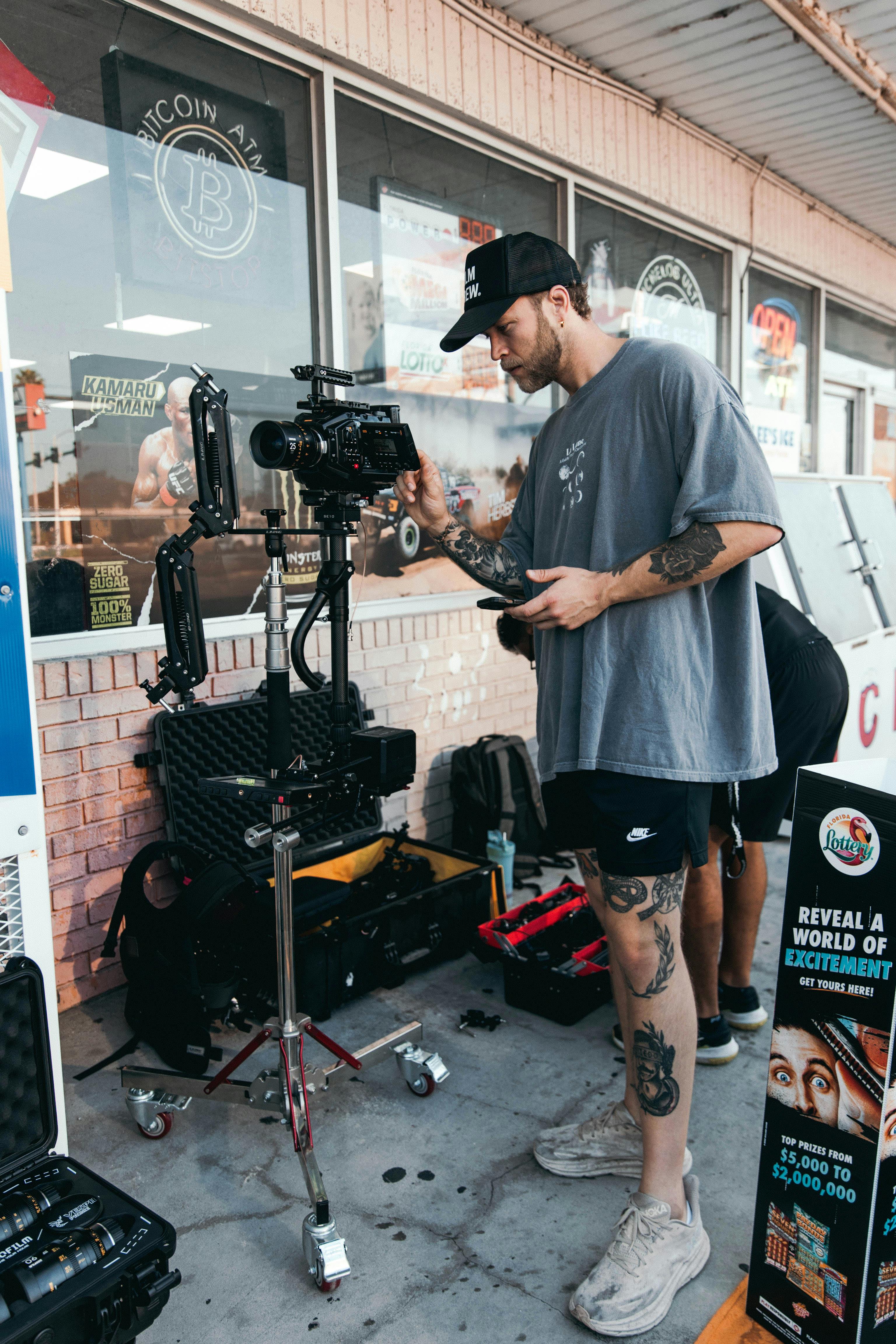 a man standing outdoors with his camera equipment.