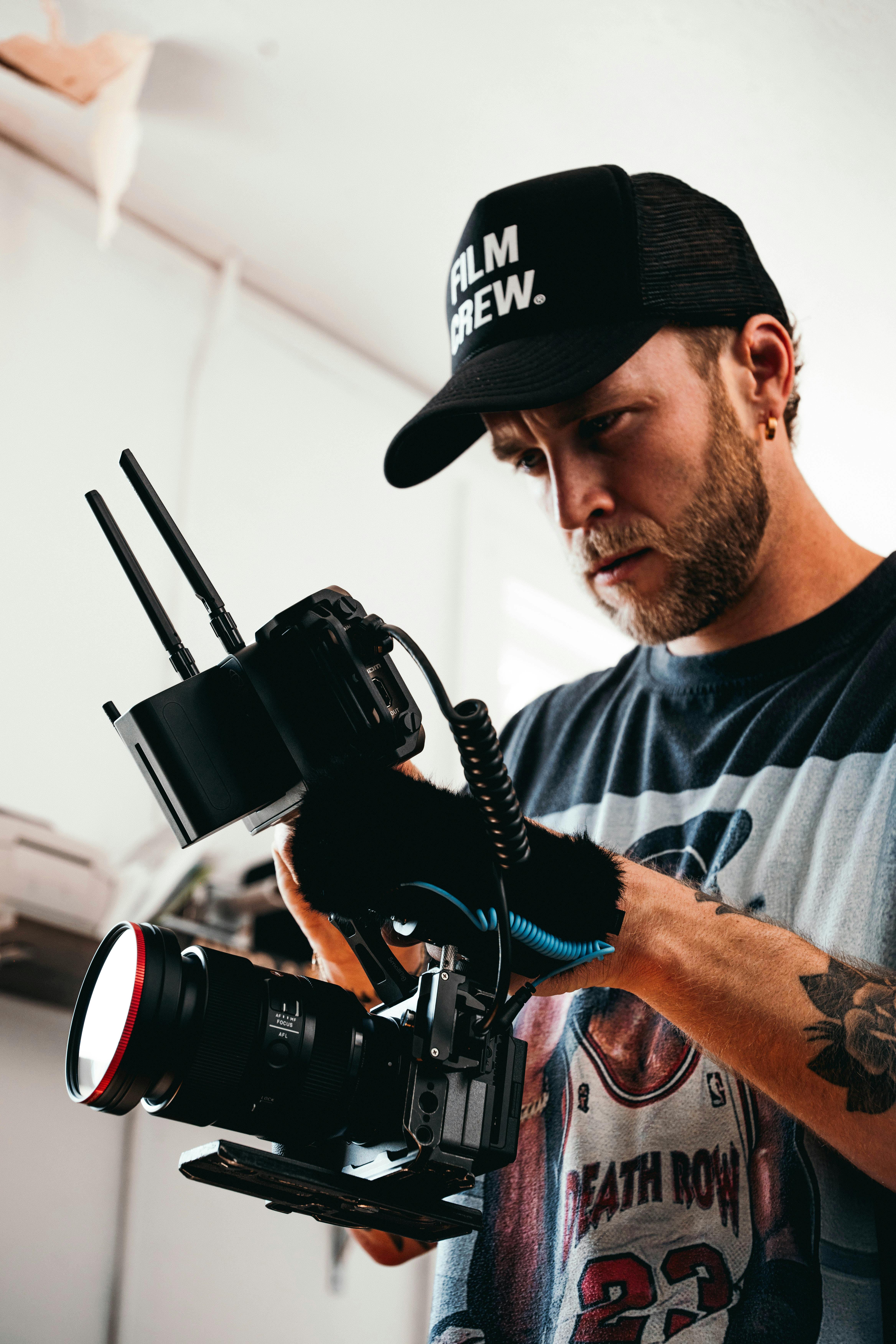 a man with a hat and gloves holding a camera