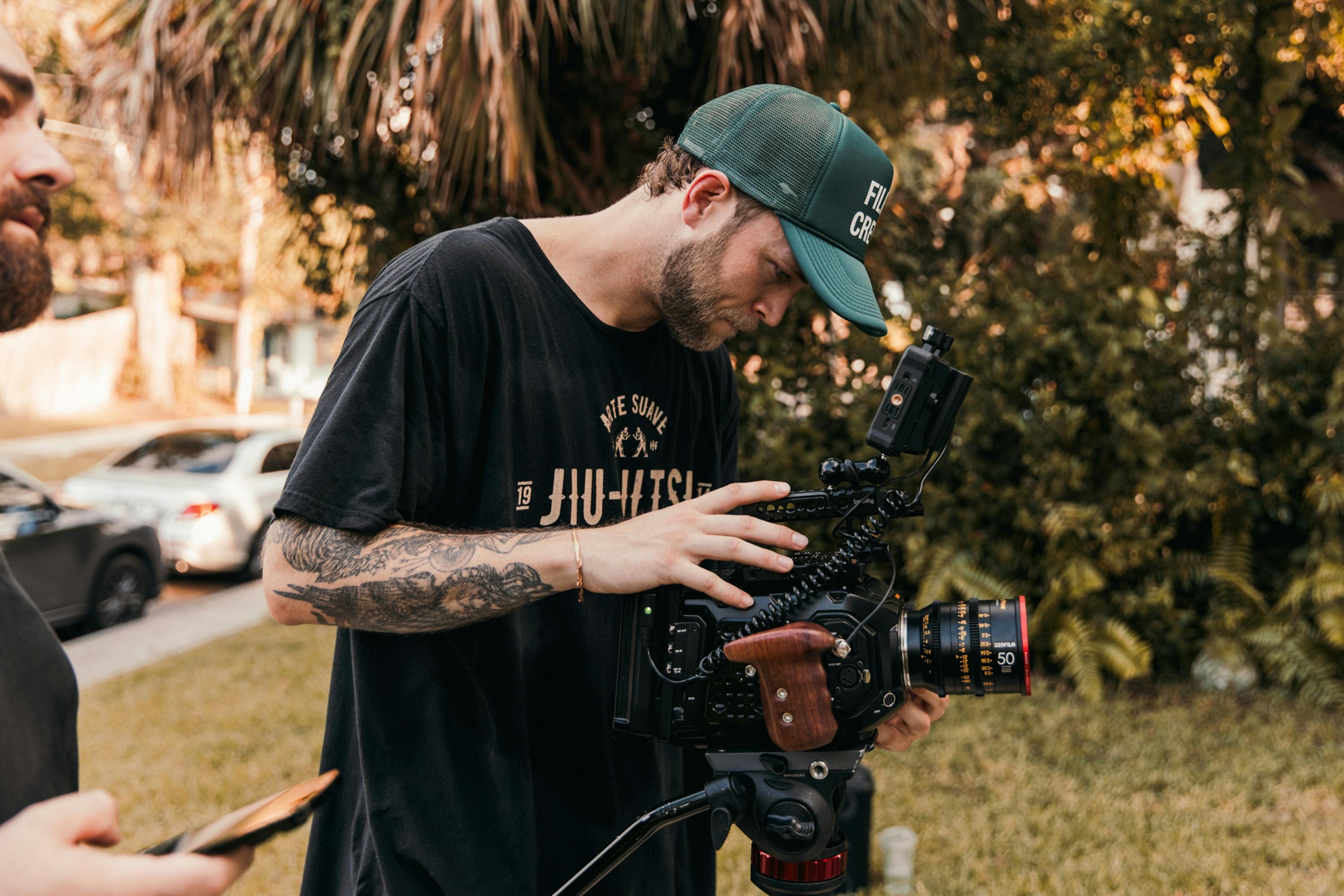 two men with tattoos and a camera