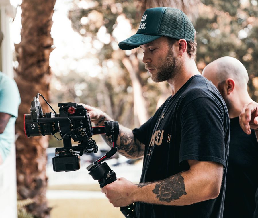 Videographer working with camera rig outdoors
