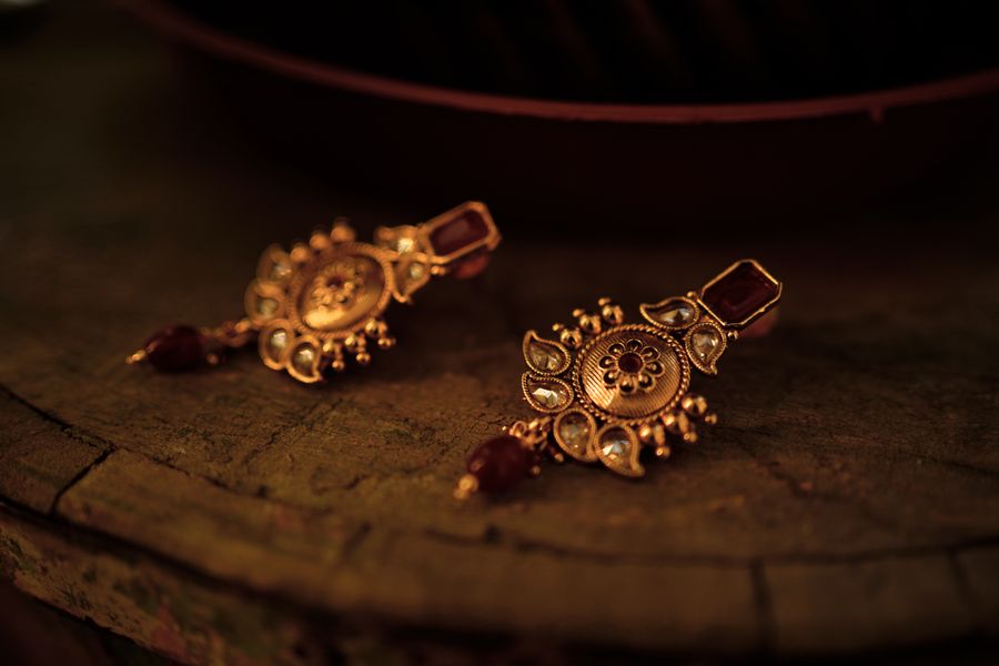 Intricate gold earrings in a velvet presentation box from the Sunlight's workshop