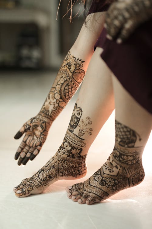 Henna Tattoos on Woman Arm and Feet