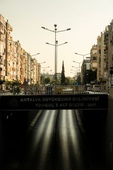 Cityscape of Antalya with buildings and a highway underpass.