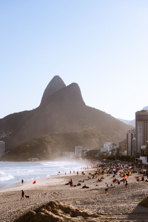 View of Ipanema Beach in Rio de Janeiro, Brazil, with the Dois Irmãos mountains in the background — one of the city's most visited stretches and also one of the highest-theft tourist zones at peak hours.