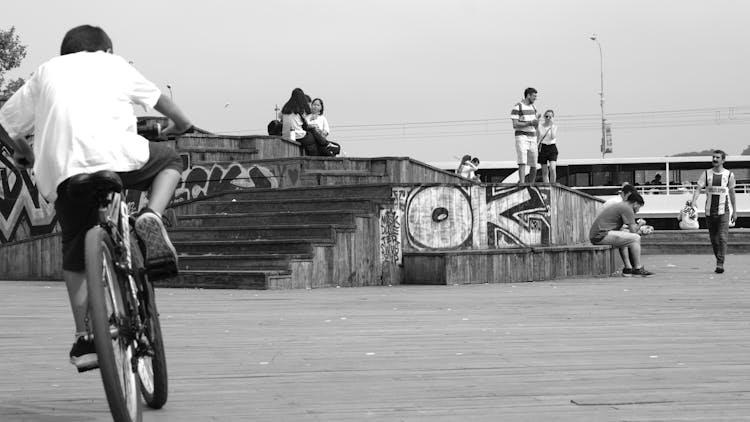 Boy Riding Bike On Town Square