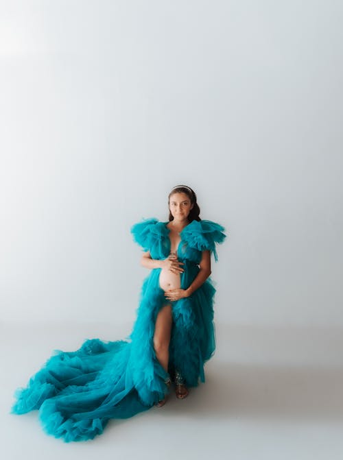 Pregnant Woman Posing in Turquoise Dress