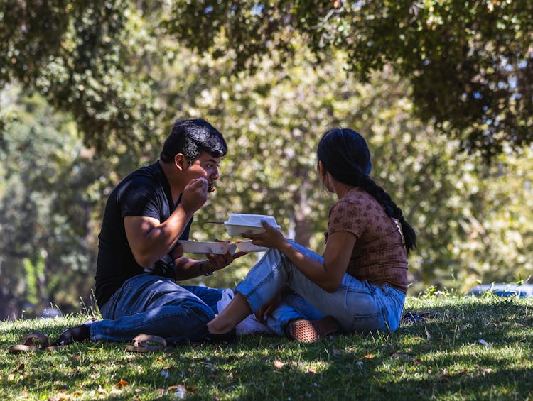 Couple Eating Take Out On The Grass