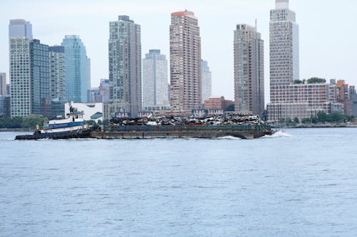 Barge with Scrap Metal Pushed by a Tugboat Along the Coast of Long Island