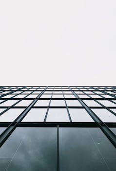 Upward view of a sleek modern glass office building facade in Santiago, Chile.