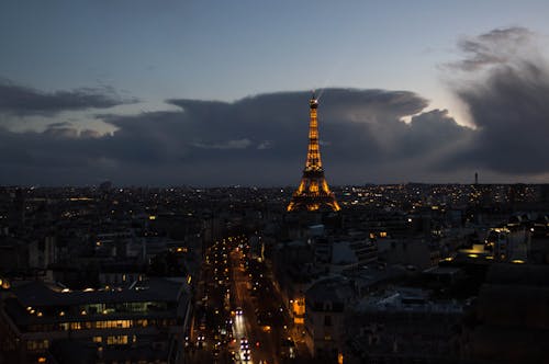 Cityscape of Paris with an Illuminated Eiffel Tower in the Evening 