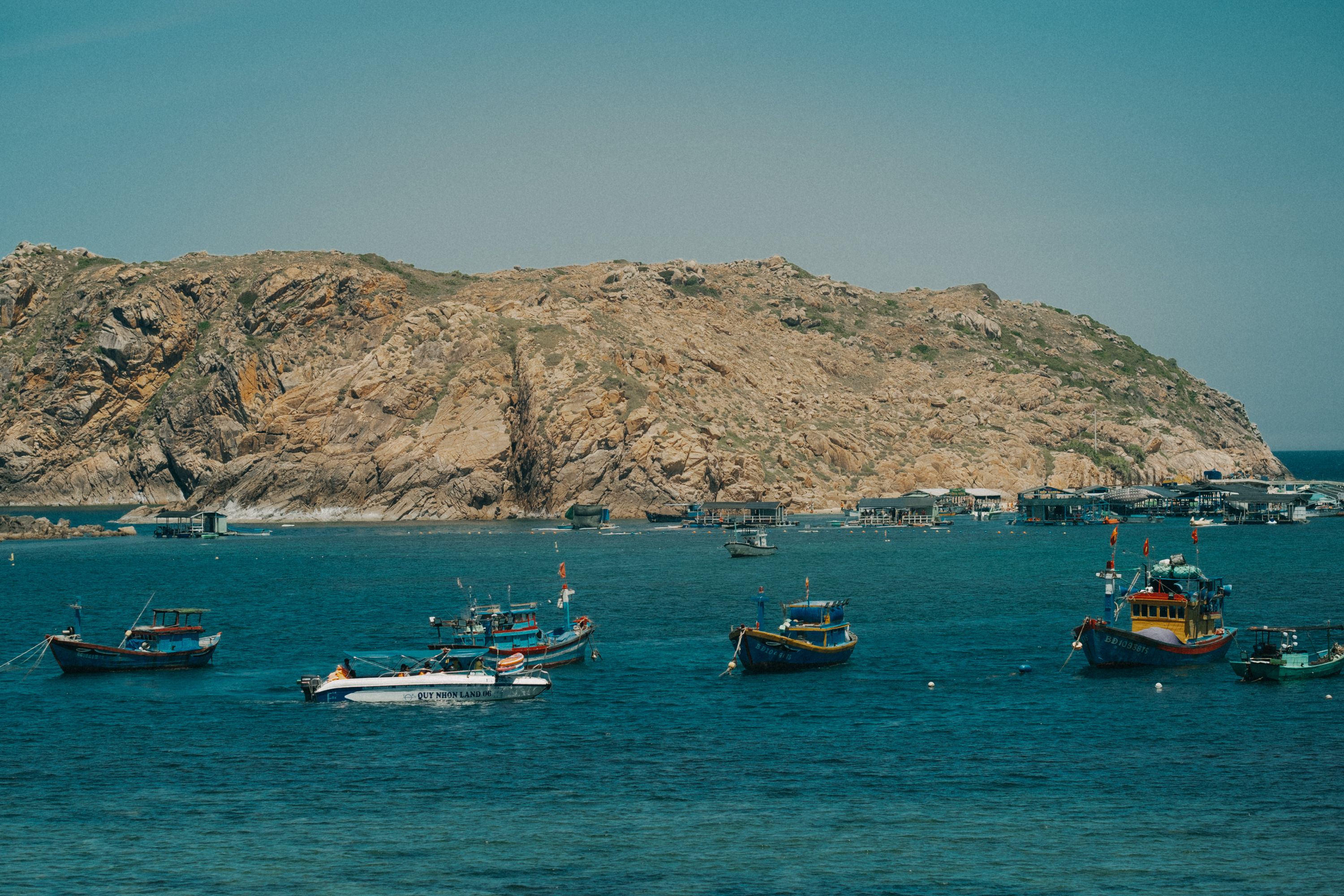 Motorboats Moored near Rocky Sea Shore · Free Stock Photo