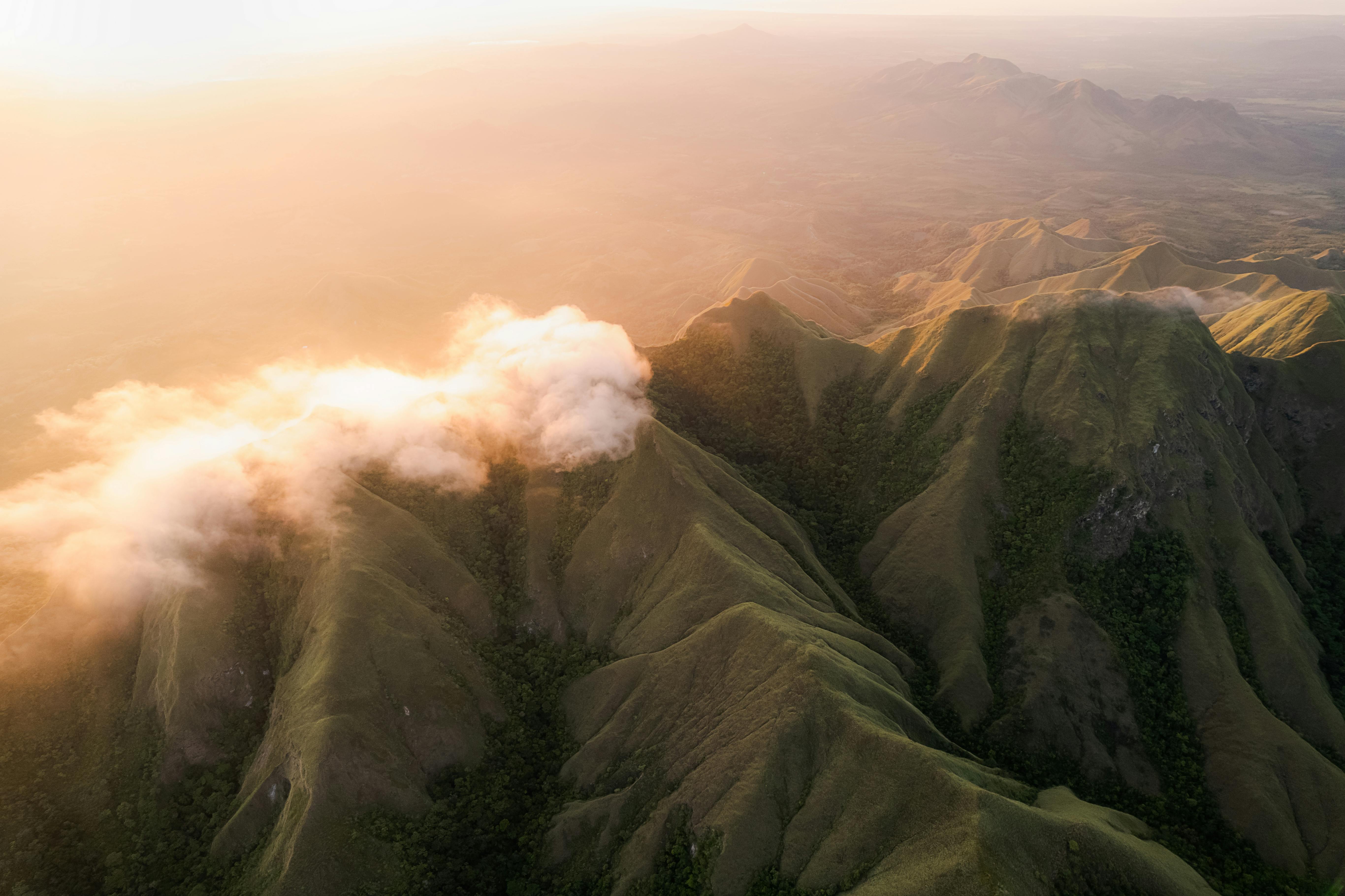 Drone shot capturing misty mountains and rolling green valleys at sunrise in Coclé, Panama — the volcanic crater province that El Valle de Antón calls home.