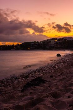 Stunning sunset over Akumal beach with vibrant skies and calm waters.