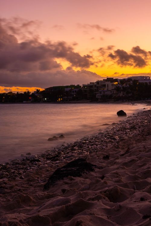 Free Stunning sunset over Akumal beach with vibrant skies and calm waters. Stock Photo