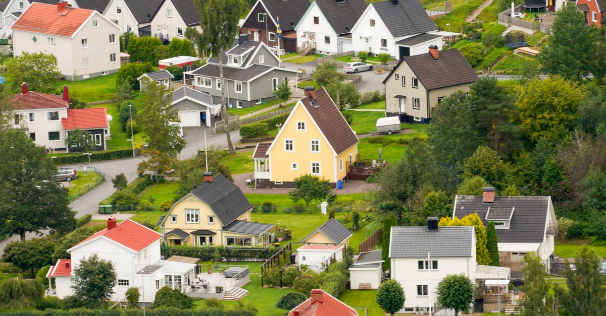 Charming aerial view of Scandinavian village houses surrounded by lush greenery.