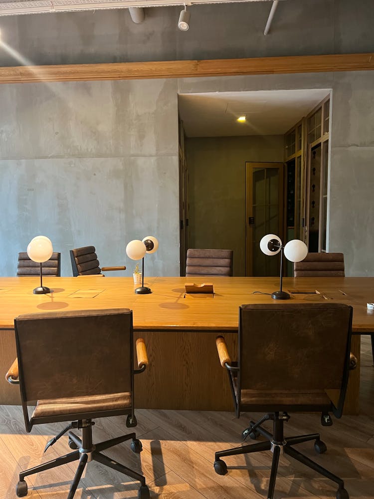 Meeting Room With Concrete Walls And Wooden Furniture